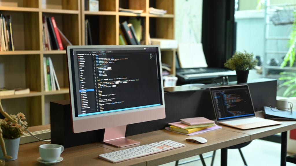 Computer pc and laptop with programming code on screen
